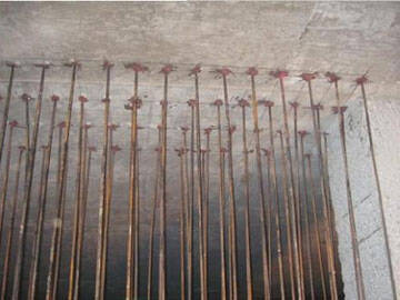 Reinforcement of shear walls by enlarging section method (post installed anchoring)